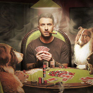 Image is of a surreal illustration of Tommy Little. Tommy has short brown hair, stubble and black tattoos on his arm. He is wearing a black t-shirt. Tommy is sitting around table playing poker with dogs. He is holding playing cards and smoking a cigar. Tommy is looking directly into the camera lens.